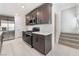 Modern kitchen featuring stainless steel appliances, white tile flooring, and gray cabinets at 4915 Chidlaw Ave # 2, Las Vegas, NV 89115