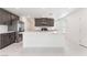 Open concept kitchen with gray cabinets, a center island and stainless appliances at 4915 Chidlaw Ave # 2, Las Vegas, NV 89115