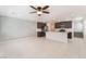 Open-concept living area with tile flooring, modern gray accent wall, and kitchen access at 4915 Chidlaw Ave # 2, Las Vegas, NV 89115