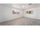 Sunlit bedroom with gray wood-look flooring and dual windows at 4980 Becky Pl, Las Vegas, NV 89120