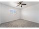 Bright bedroom features neutral carpet, a ceiling fan, and natural light from the window at 4980 Becky Pl, Las Vegas, NV 89120