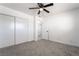 Bedroom with neutral carpet, ceiling fan, closet space, and entryway at 4980 Becky Pl, Las Vegas, NV 89120