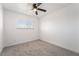 Bright bedroom with neutral carpet, a ceiling fan, and natural light from the window at 4980 Becky Pl, Las Vegas, NV 89120