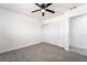 Bedroom with neutral carpet, a ceiling fan, closet space, and entry to updated bathroom at 4980 Becky Pl, Las Vegas, NV 89120