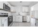 Updated kitchen with stainless steel appliances and white cabinets and countertops at 4980 Becky Pl, Las Vegas, NV 89120