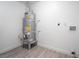 Water heater with connections in a utility room with wood laminate flooring at 4980 Becky Pl, Las Vegas, NV 89120