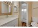 Bright bathroom features a quartz countertop vanity and a shower with sliding glass doors at 5065 Atherton St, Las Vegas, NV 89120