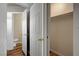 Hallway with a closet, showing a doorway into a bathroom with wood floors at 5065 Atherton St, Las Vegas, NV 89120
