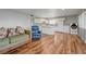 Open concept living room and kitchen area with sleek wood floors at 5065 Atherton St, Las Vegas, NV 89120