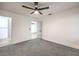 Neutral bedroom with carpet, ceiling fan and view to the entry at 5101 Village Dr, Las Vegas, NV 89142