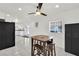 Bright dining area featuring tiled floors, a ceiling fan, and a table with chairs at 5376 Hillsboro Ln, Las Vegas, NV 89120