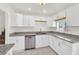 Bright kitchen featuring white cabinets, granite countertops, and stainless steel dishwasher at 5376 Hillsboro Ln, Las Vegas, NV 89120