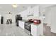 Open concept kitchen featuring white cabinets, granite countertops, and modern appliances at 5376 Hillsboro Ln, Las Vegas, NV 89120