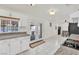 Open kitchen featuring tiled floor, granite countertops, white cabinets, and view to the pool at 5376 Hillsboro Ln, Las Vegas, NV 89120