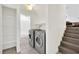 Modern laundry room with washer, dryer, and adjacent bathroom for added convenience at 5376 Hillsboro Ln, Las Vegas, NV 89120