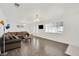 Bright living room featuring hardwood floors, a large window, and a comfortable couch at 5376 Hillsboro Ln, Las Vegas, NV 89120