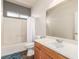 A bright bathroom features a shower-tub combination and a large mirror over the vanity at 5932 Lamotte Ave, Las Vegas, NV 89141