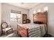 This bedroom features an antique bed frame, chair, dresser, and abundant natural light at 5932 Lamotte Ave, Las Vegas, NV 89141