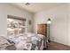 Cozy bedroom featuring a large window with natural light and hardwood floors at 5932 Lamotte Ave, Las Vegas, NV 89141