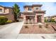 Inviting two-story home featuring a neutral color palette, well-kept landscaping, and a spacious driveway at 5932 Lamotte Ave, Las Vegas, NV 89141