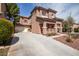 Charming two-story home with a spacious driveway and terracotta-tiled roof, complemented by desert landscaping at 5932 Lamotte Ave, Las Vegas, NV 89141