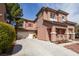 Charming two-story home with a spacious driveway and terracotta-tiled roof, complemented by desert landscaping at 5932 Lamotte Ave, Las Vegas, NV 89141