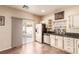 Kitchen shows light cabinets, tile floor, and view out to an inviting patio and pool at 5932 Lamotte Ave, Las Vegas, NV 89141