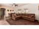 Open-concept living and dining area with a sectional sofa, ceiling fan, and ample natural light at 5932 Lamotte Ave, Las Vegas, NV 89141