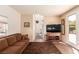 Bright living room featuring a comfortable sofa, ceiling fan, and a hallway leading to other rooms at 5932 Lamotte Ave, Las Vegas, NV 89141