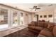 Spacious living area with a brown sectional, recessed lighting, and glass doors leading to the backyard at 5932 Lamotte Ave, Las Vegas, NV 89141