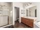 Bright main bathroom with shower, soaking tub, and vanity with large mirror at 5932 Lamotte Ave, Las Vegas, NV 89141