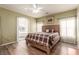 Comfortable main bedroom with ensuite bathroom, wood floors, ceiling fan and natural light at 5932 Lamotte Ave, Las Vegas, NV 89141