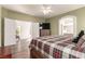 Charming main bedroom with wood floors, ensuite, television, and natural light at 5932 Lamotte Ave, Las Vegas, NV 89141