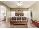 Spacious main bedroom with wood floors, ceiling fan, ensuite with bathtub and walk-in closet at 5932 Lamotte Ave, Las Vegas, NV 89141