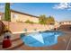 The backyard features a refreshing blue pool with planters and a seating area at 5932 Lamotte Ave, Las Vegas, NV 89141