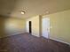 A carpeted bedroom offers a built-in closet, paneled doors, and neutral walls for a modern, cozy feel at 6093 Crown Palms Ave, Las Vegas, NV 89139