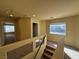 Second floor hallway features natural light, neutral decor, and staircase at 6093 Crown Palms Ave, Las Vegas, NV 89139