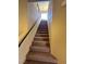 Carpeted stairway with a black handrail leading to the upper level at 6093 Crown Palms Ave, Las Vegas, NV 89139