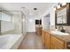 A large primary bathroom features granite counters, dual sinks, a shower, and a separate soaking tub at 6130 Tara Ave, Las Vegas, NV 89146
