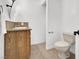 Compact bathroom featuring wood vanity, tile flooring, and a standard toilet at 6130 Tara Ave, Las Vegas, NV 89146