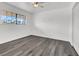 Bright bedroom with a ceiling fan and large window with a view to the outside at 6130 Tara Ave, Las Vegas, NV 89146