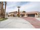 Spacious home features a well manicured yard, mature palm trees, and a large driveway for ample parking at 6130 Tara Ave, Las Vegas, NV 89146