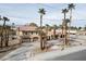 Exterior view of a desert home with palm trees and a tile roof at 6130 Tara Ave, Las Vegas, NV 89146