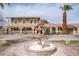 Home exterior with a fountain, palm trees, and arched window accents give the home an inviting curb appeal at 6130 Tara Ave, Las Vegas, NV 89146