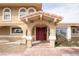 An inviting front door with arched portico, brick steps, and traditional design elements gives the entrance character at 6130 Tara Ave, Las Vegas, NV 89146