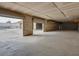 An expansive, unfinished garage area shows cinder block walls and high ceilings with room for storage at 6130 Tara Ave, Las Vegas, NV 89146