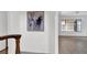 Hallway featuring tile floors and art on the walls leads to a living room with grid windows at 6130 Tara Ave, Las Vegas, NV 89146