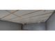 Unfinished interior with gray walls, exposed ceiling beams and lighting fixtures offers potential for customization at 6130 Tara Ave, Las Vegas, NV 89146