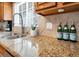 A kitchen showcasing granite countertops, a stainless steel sink, and wooden cabinetry at 6130 Tara Ave, Las Vegas, NV 89146