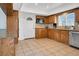 Traditional kitchen features wood cabinets, stainless steel appliances, and tile countertops for timeless functionality at 6130 Tara Ave, Las Vegas, NV 89146